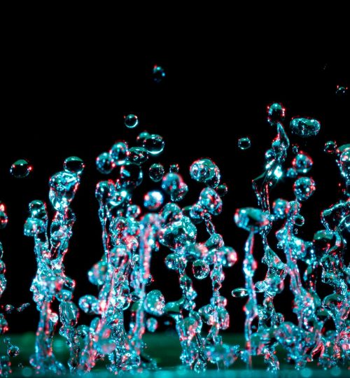 A striking close-up of vibrant water droplets capturing motion and abstract beauty.